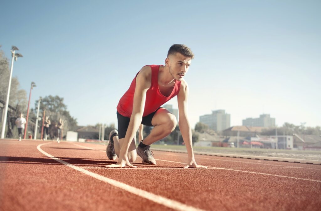 atlhetic men in a racetrack prepared to run