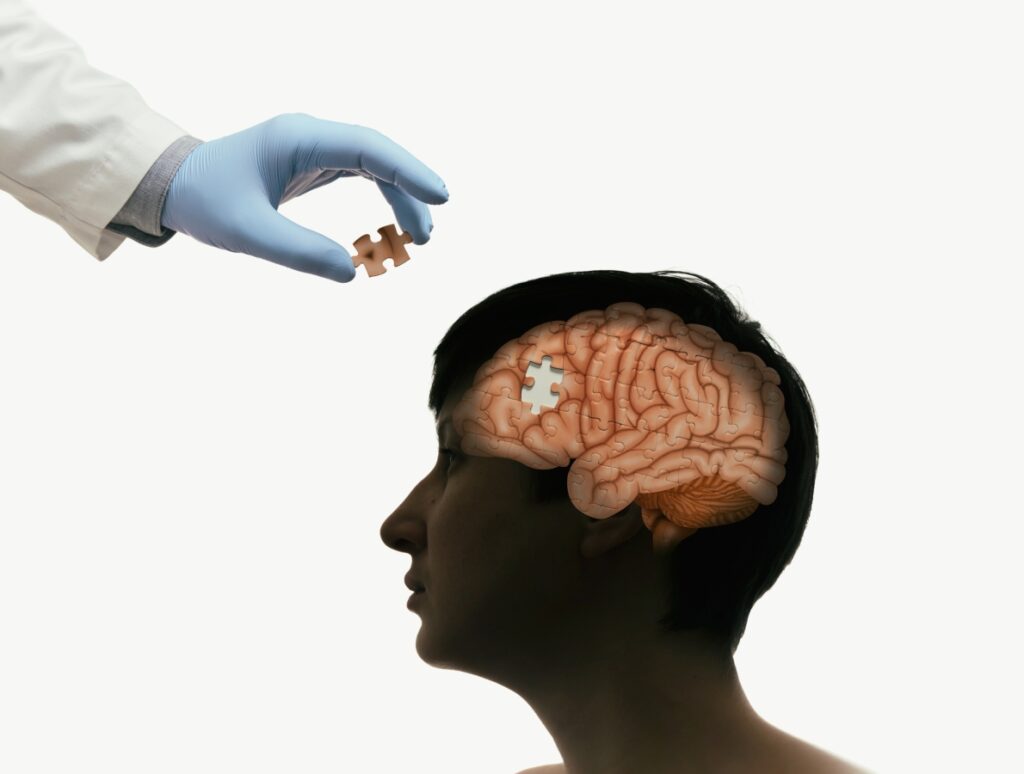 brain puzzle with a missing piece handled by a doctor's hand with nitrile gloves