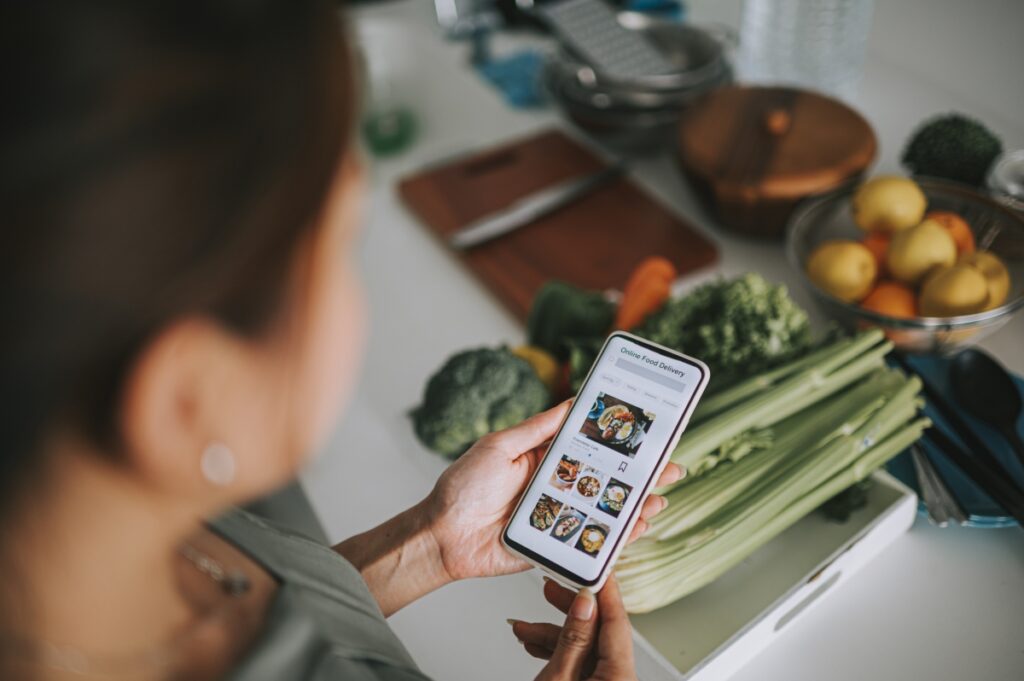 woman looking at her phone checking a recipe