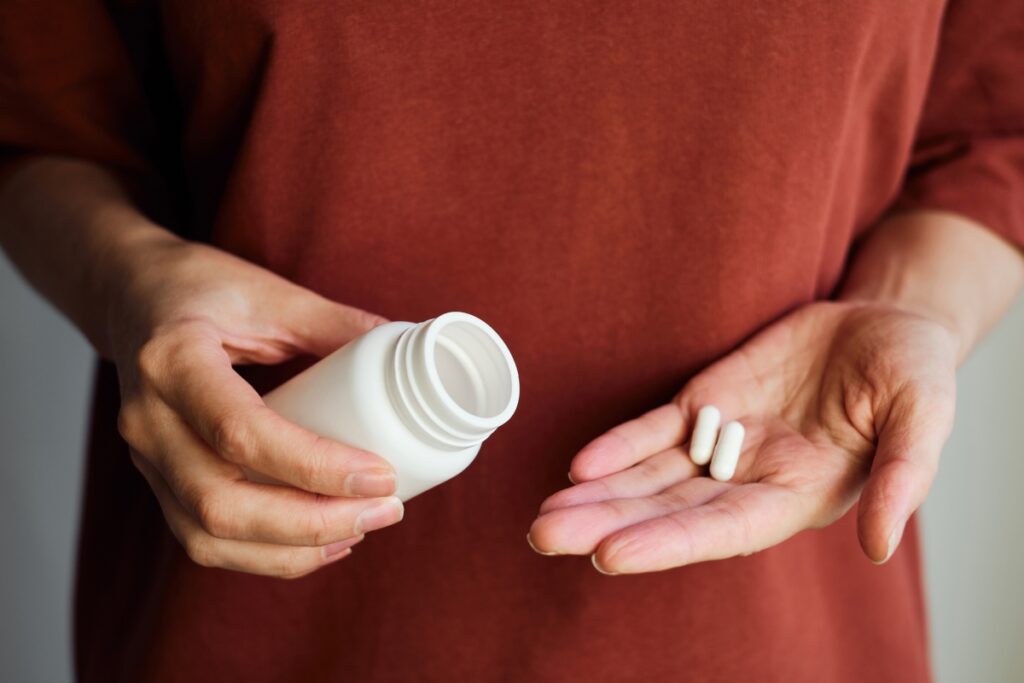 woman serving two pills of magnesium pills