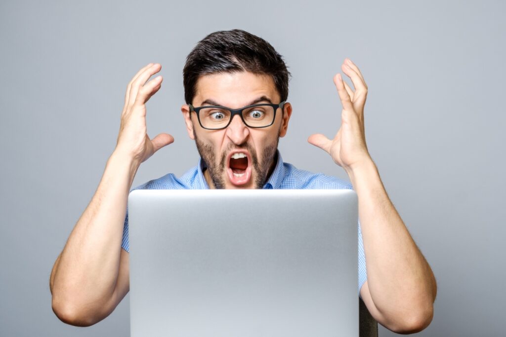 intellectual man screaming to his laptop