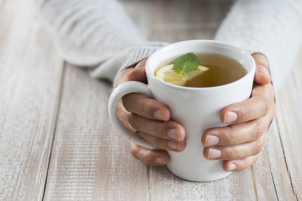 Herbal tea on wood background.