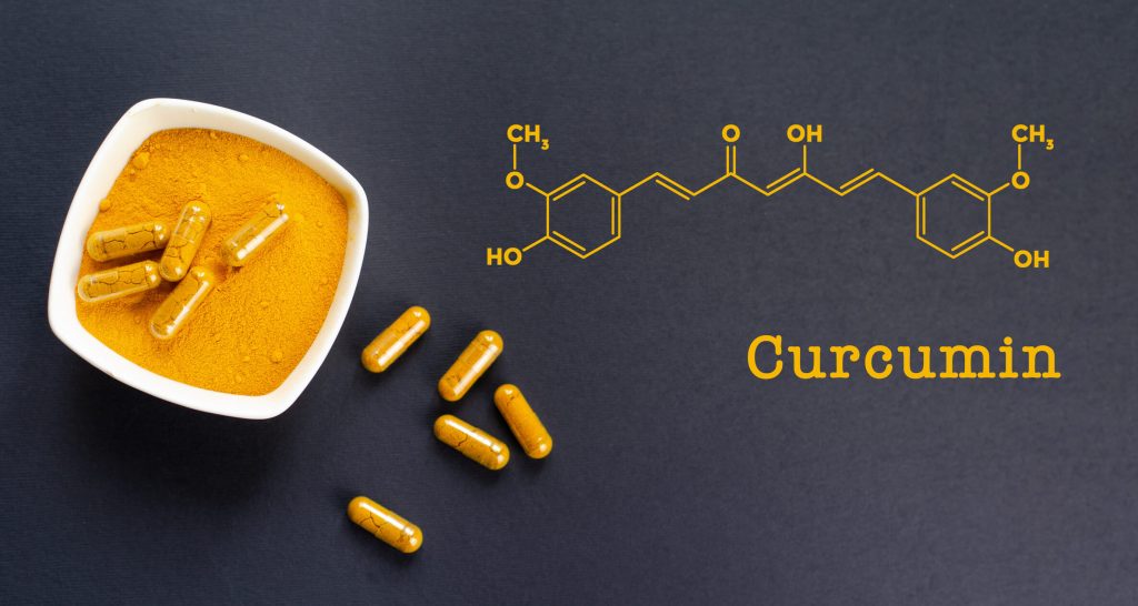Curcumin skeletal chemical formula with a photo of yellow turmeric root powder.